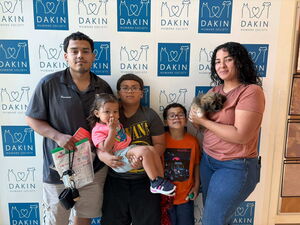 Family poses with new puppy adopted at Dakin Humane Society