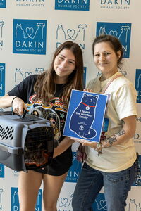 Two adopters leaving Dakin with new cat