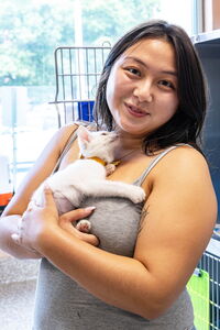 Woman holding white kitten at Dakin