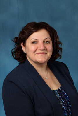Photo of Gina Barry on a blue background