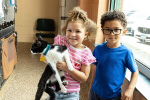 2 children holding a cat at Dakin