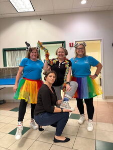 Dakin staff & volunteers in colorful skirts for Spirit Week