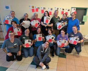 Dakin staff and volunteers celebrate the end of a successful day of adoptions