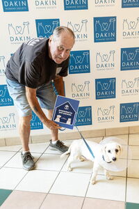 Man with newly-adopted dog leaving Dakin
