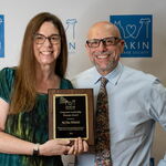 Award recipients standing with an award plaque