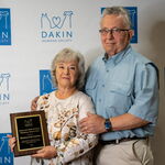 Award recipients standing with an award plaque