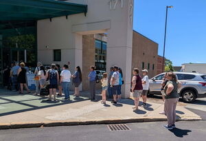 A line of people wait outside for Dakin's Discounted Adoption Fee for Cats/Kittens to begin