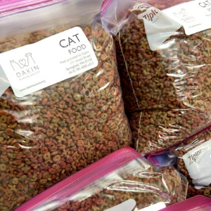 An image of dry cat food sorted into plastic bags with pink ziplock zippers